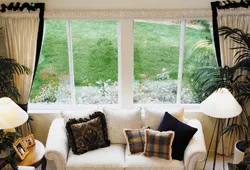 beautiful window along with sofa placed inside a house